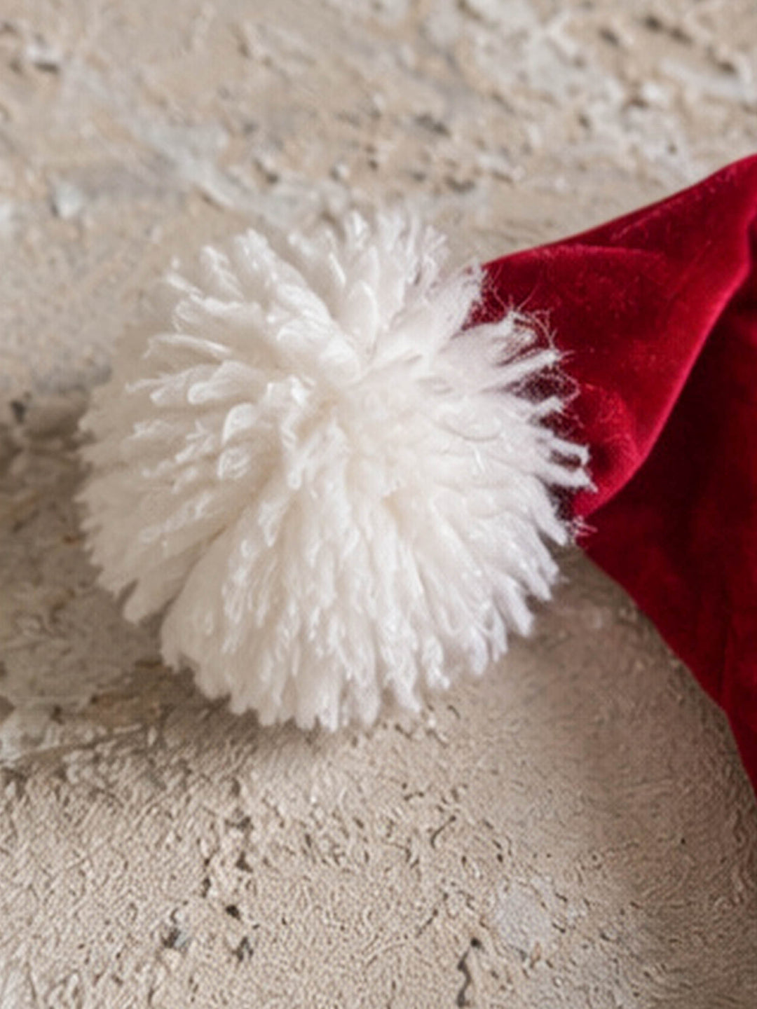 Velvet Santa Hat in deep red, close up of the big fluffy white pom-pom - Before & Ever Kids