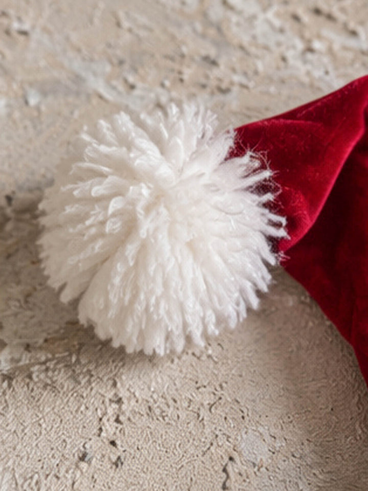 Velvet Santa Hat in deep red, close up of the big fluffy white pom-pom - Before & Ever Kids