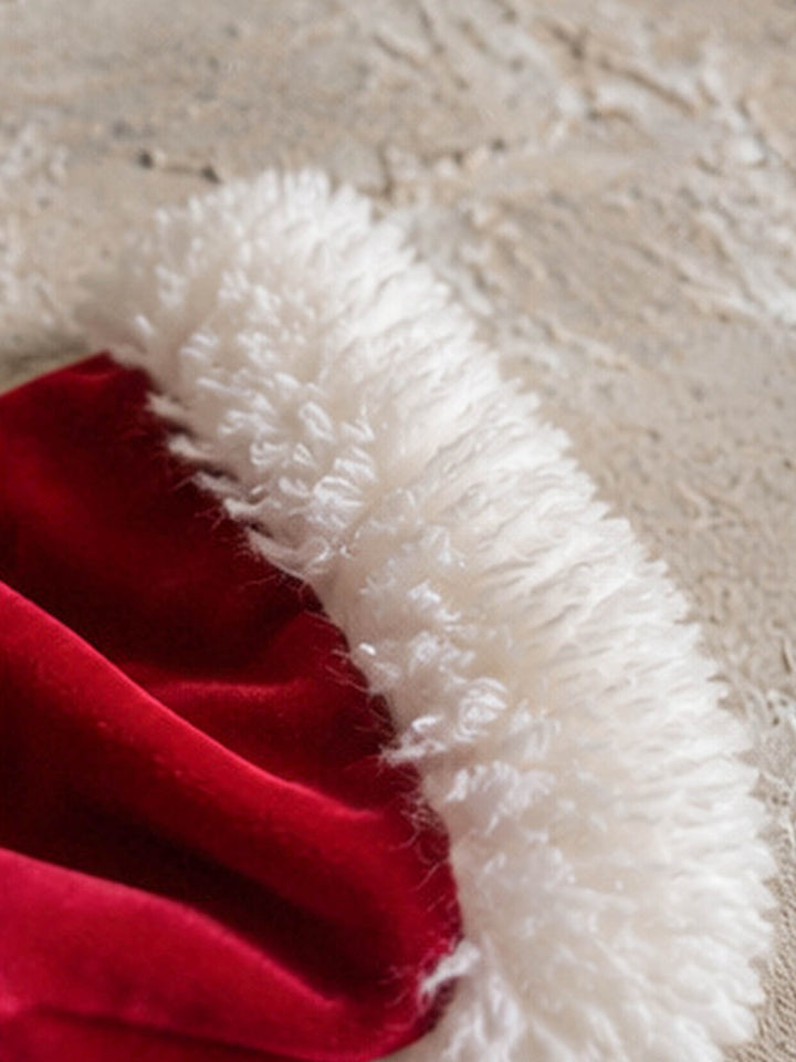 Velvet Santa Hat in deep red, close up of the curly white trim against the red velvet - Before & Ever Kids