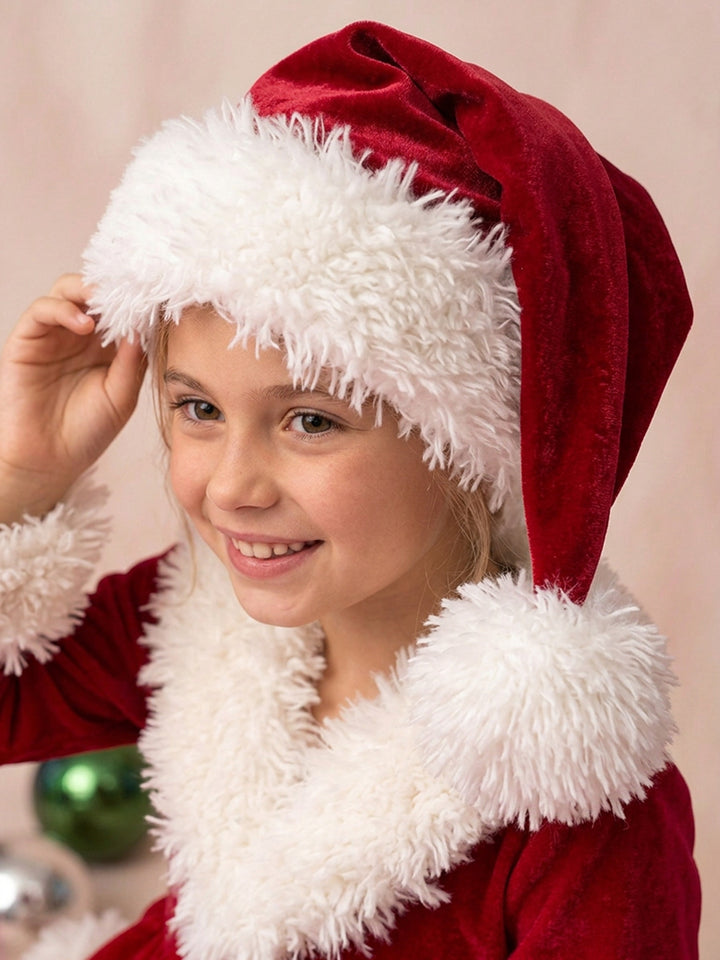 Velvet Santa Hat in deep red, worn by a smiling girl, curly white trim framing her face - Before & Ever Kids