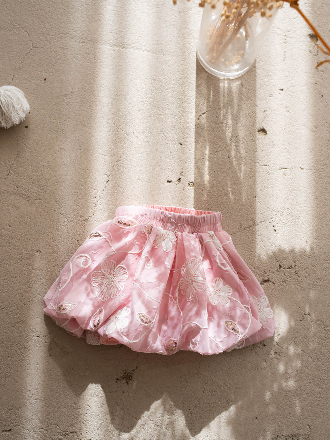 Where Summer Blooms baby pink baby girl set with white floral embroidery, gold sequins, puff sleeves and a bubble-hem skort.