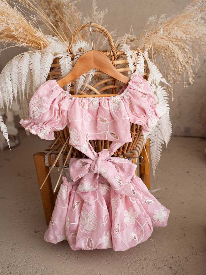 Where Summer Blooms baby pink baby girl set with white floral embroidery, gold sequins, puff sleeves and a bubble-hem skort.